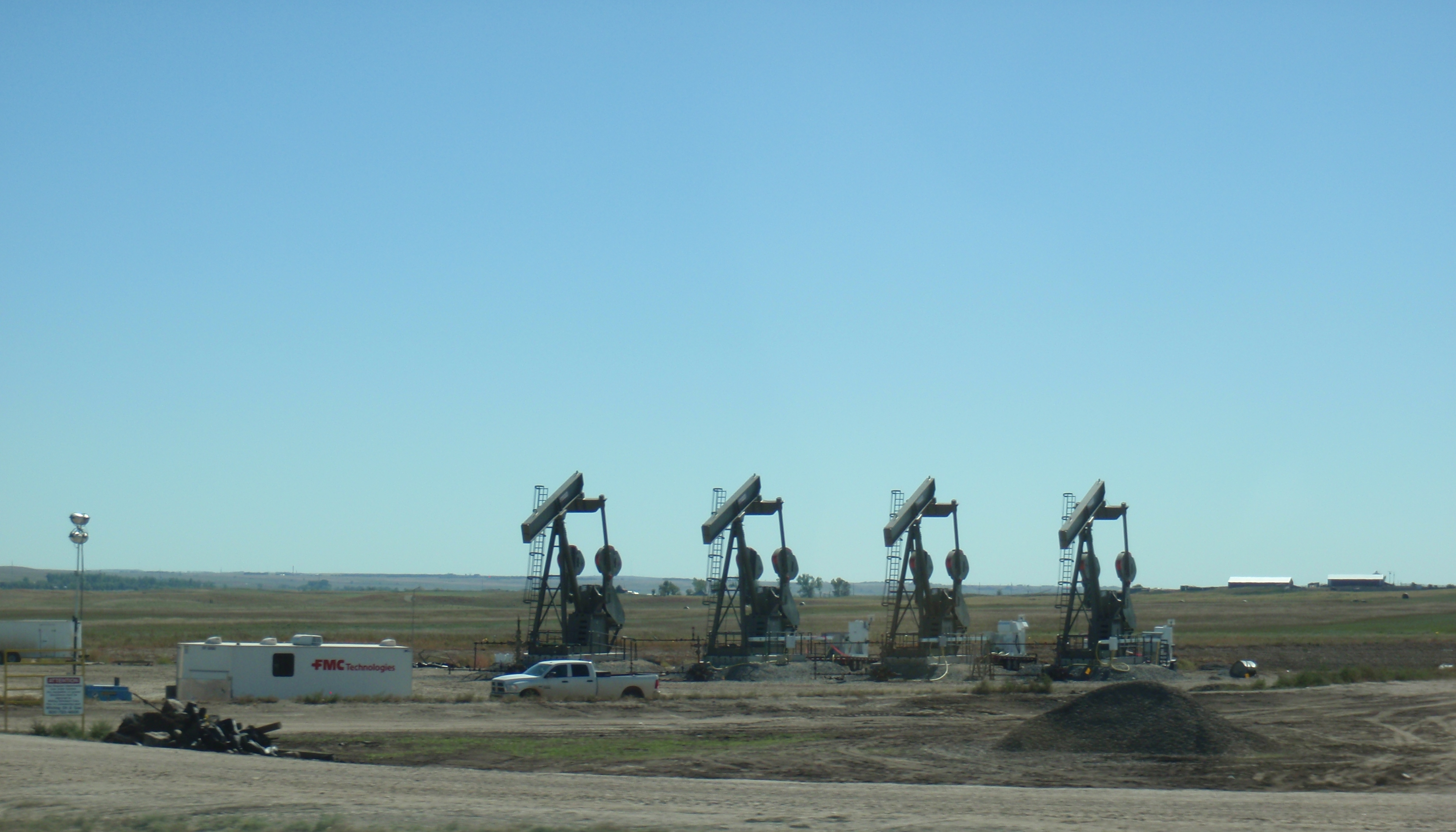 Pumps on new wells being installed in 9/15. Not exactly a sign of a collapsed industry. Photo by James Ulvog.