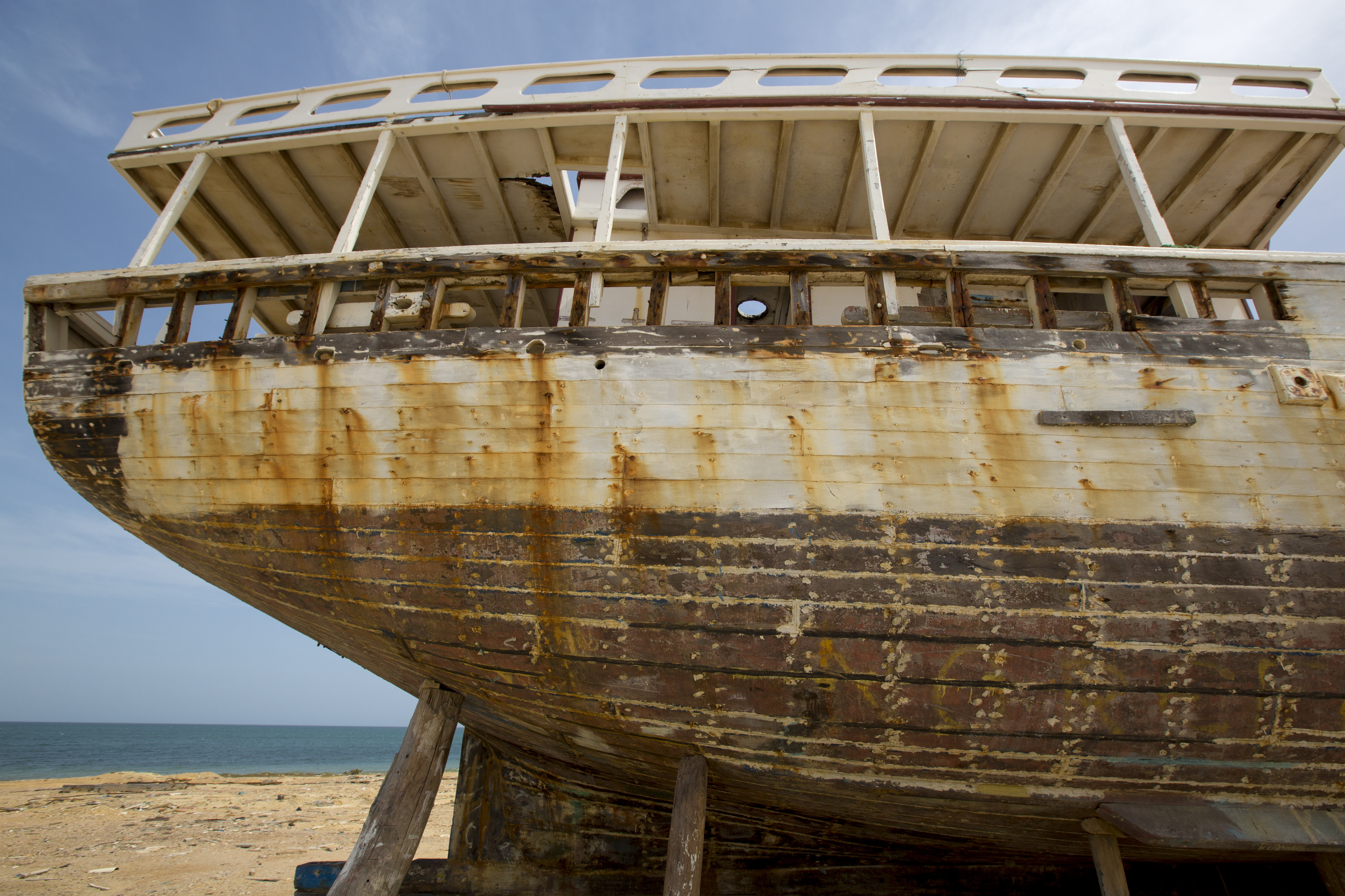 Shipwreck standing on the beach with the sea in the background. Margarita Island. Venezuela. Photo courtesy of DollarPhotoClub.com